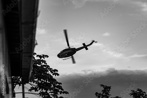 Helicopter providing air support during a Civil Police operation to combat organized crime, and drug trafficking, in a community (favela) in Rio de Janeiro, Brazil. photo