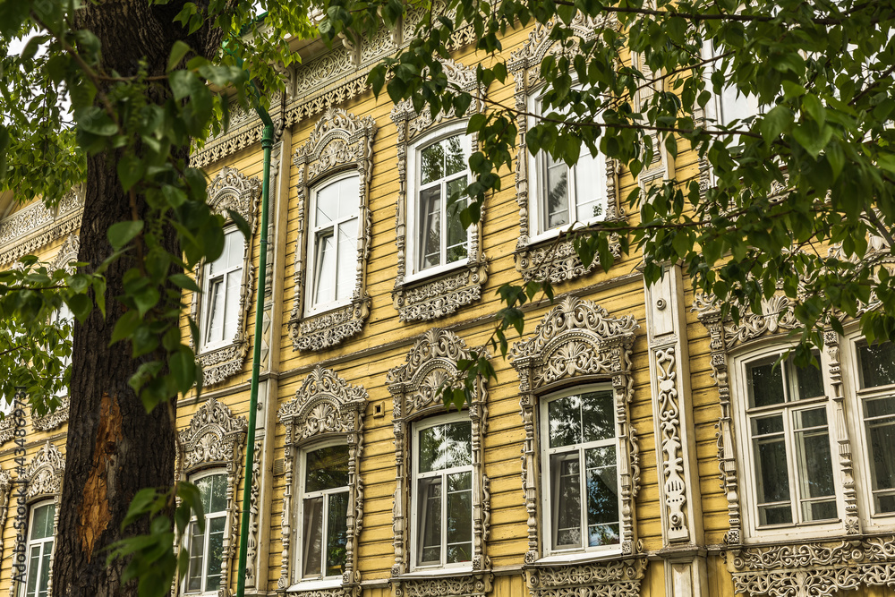 Fototapeta premium Windows with carved platbands of an old wooden house