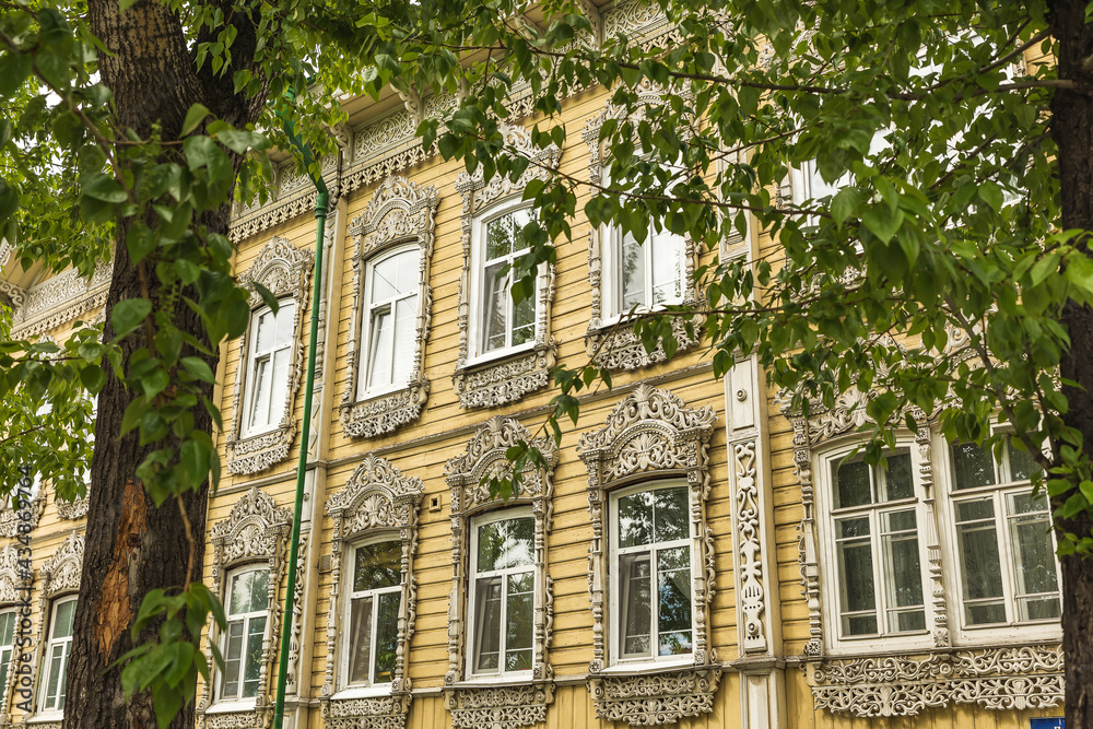 Fototapeta premium Windows with carved platbands of an old wooden house