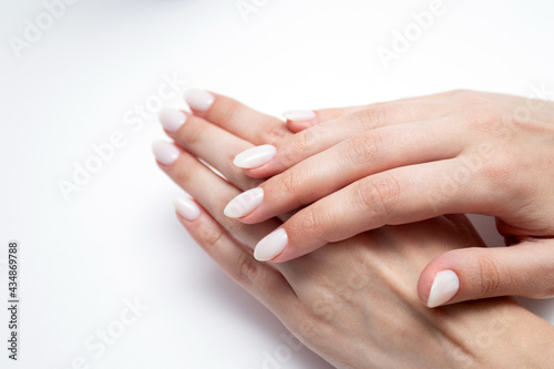 Woman s hands with professional manicure in beige colors
