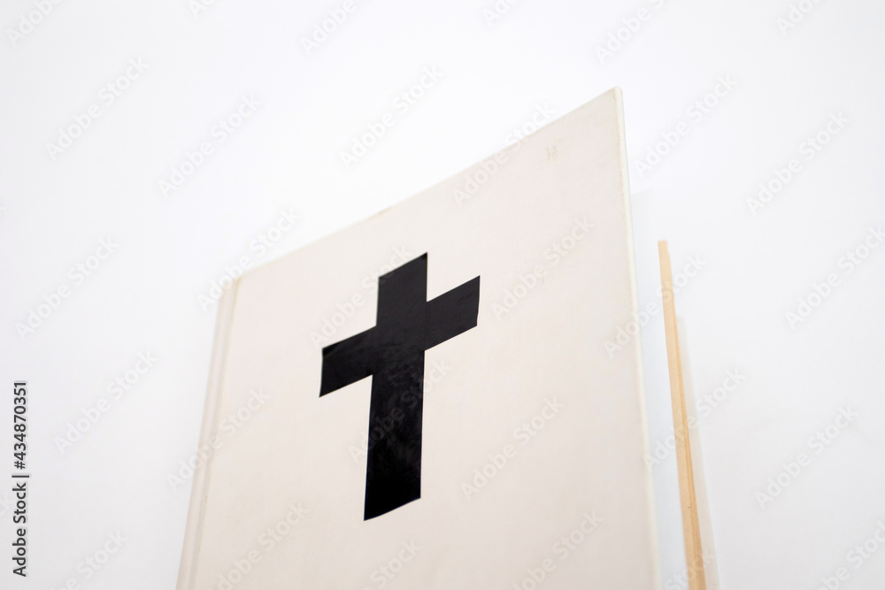Fototapeta premium White book with a cross on the cover. Holy Bible
