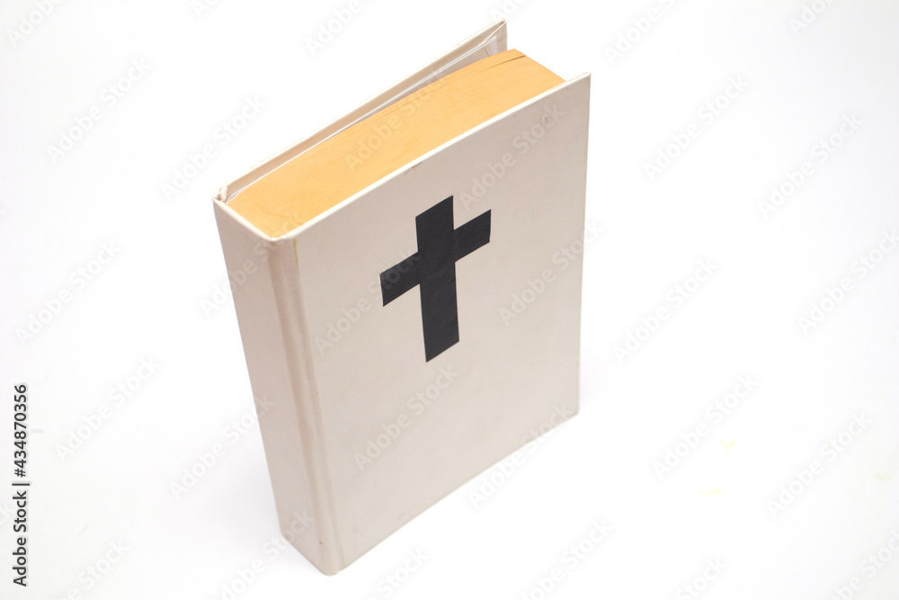 Fototapeta premium White book with a cross on the cover