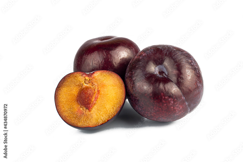 Whole and half ripe plums isolated on white background. Natural and organic purple cherry plums. Part of set.