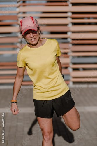 Young latin woman doing stretch exercises. © Felix