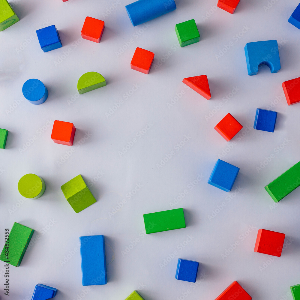 Colorful wooden blocks on light background. Creativity toys. Geometric shapes - cube, triangular prism, cylinder. The concept of logical thinking with copy space. Colorful wooden blocks on light background. Creativity toys. Geometric shapes - cube, triangular prism, cylinder. The concept of logical thinking with copy space.