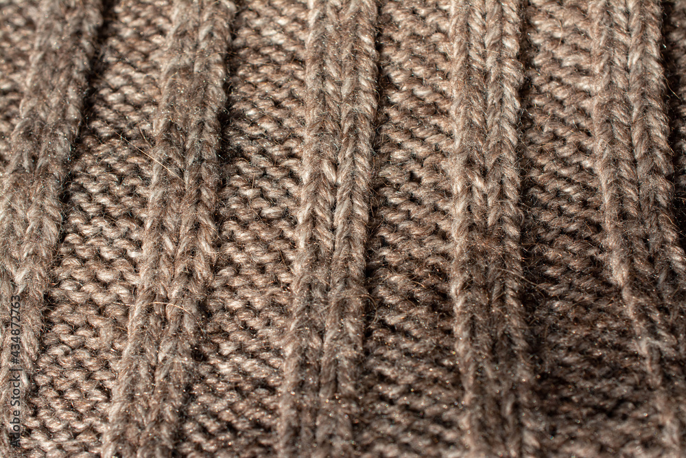 Close up of the collar of a large knitted jumper. With a rib stitch pattern. Heathered beige colour. Close up of the collar of a large knitted jumper. With a rib stitch pattern. Heathered beige colour.