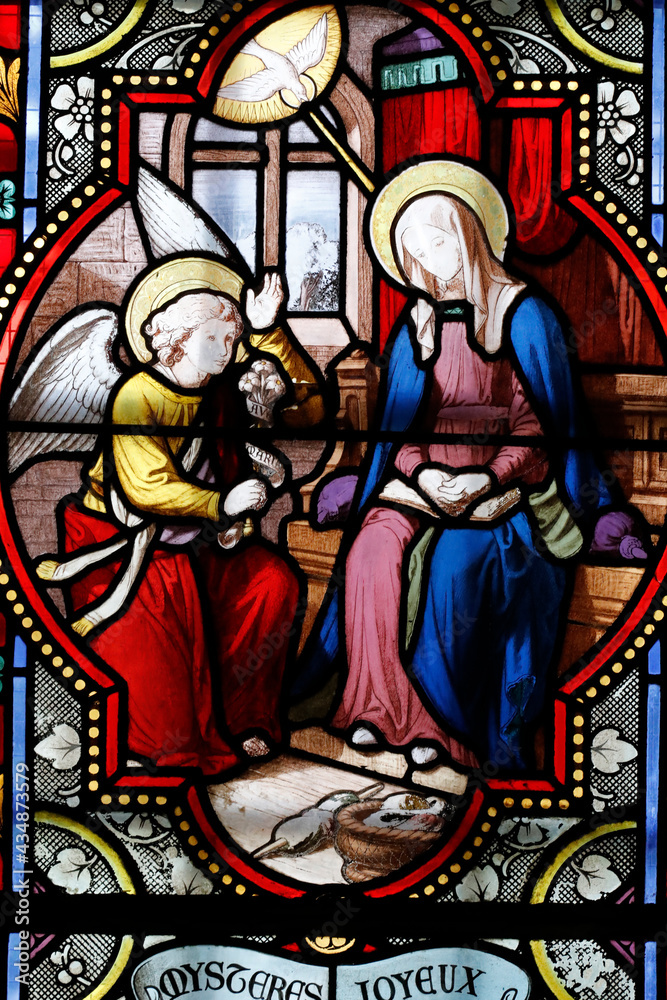 Cordeliers church.  Stained glass window.  The Annunciation is the announcement by the angel Gabriel to the Virgin Mary that she will become the mother of Jesus.  Lons le Saunier. France.