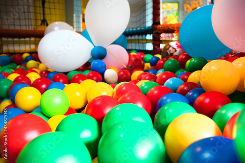 Colorful plastic balls and a few balloons on the playground