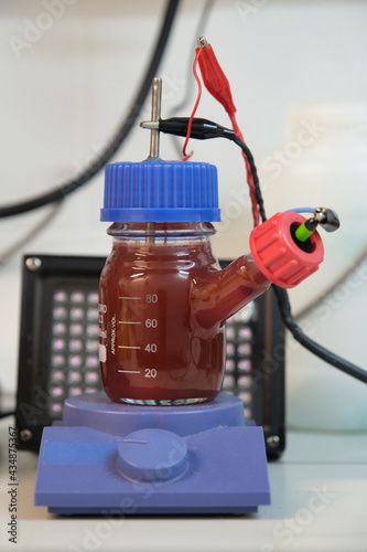 Canvas Print Anaerobic purple and red Photobacteria cultures in a microbial fuel cell, illuminated with infrared illuminators
