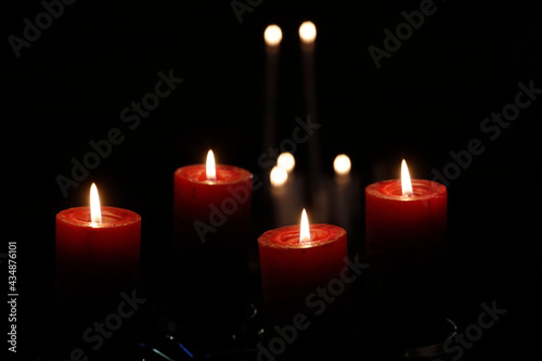 Natural advent wreath or crown in a catholic church with Four burning red candles.   France.