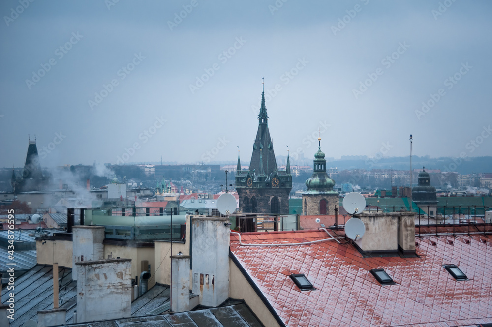 first snow on the rooftops of the center of Prague top view
