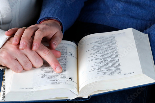 Man and woman reading together the bible at home. Christian couple living in the love of God and Jesus.   France.