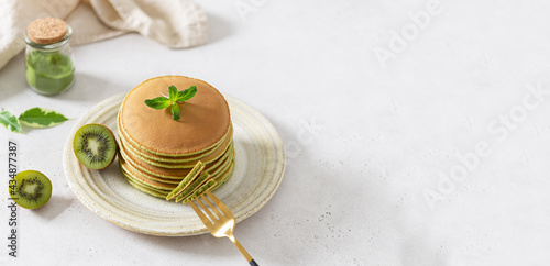 Pancakes banner. Green pancakes with matcha tea. Ideas and recipes for healthy breakfast with superfood ingredients. Menu, matcha recipe. Copy space