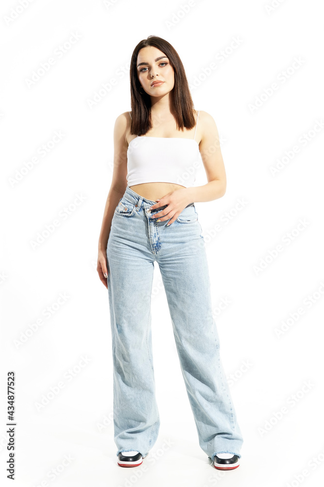 Pretty casual summer style clothing girl posing and looking at camera. Full body length isolated on white background Pretty casual summer style clothing girl posing and looking at camera. Full body length isolated on white background