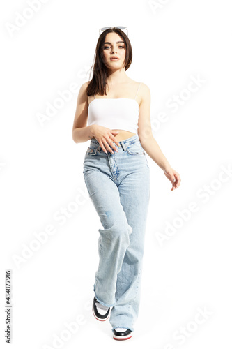 Feminine beauty summer girl in casual street style clothes posing at camera. Full body length isolated on white background