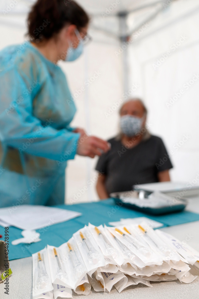 Obraz premium COVID-19 vaccination center. Man receiving Covid 19 vaccination. Saint-Gervais. France.