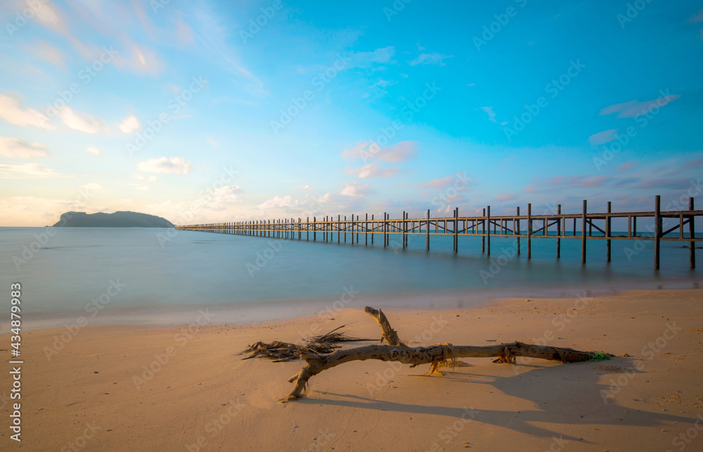 Wooden bridge on the tropical beach and blue sky summer background