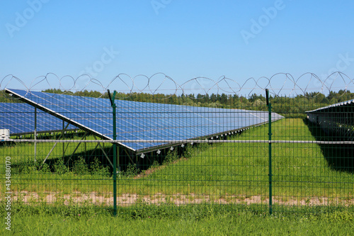 Solar panel on the field behind the barbed wire