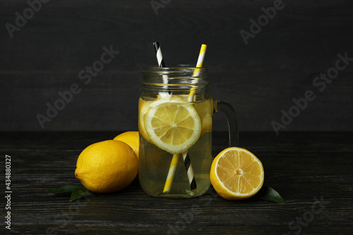 Jar of lemonade on wooden background, close up