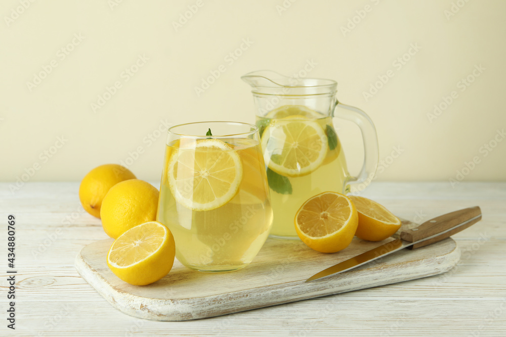 Concept of fresh summer drink with lemonade on white wooden table Concept of fresh summer drink with lemonade on white wooden table