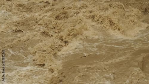 Disaster flood deluge and water flow after rainfall. Weather cataclysm. Raging river with dirty water. Natural disasters, extreme weather.