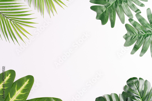 Tropical leaves frame each other leaving space in between  summer background