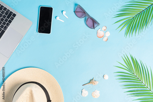 Top view photo of beach accessories on a blue background