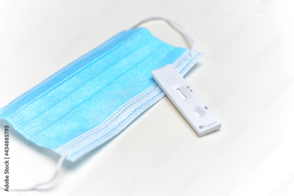 Lateral flow test to check for covid-19 virus and face mask isolated on white background Lateral flow test to check for covid-19 virus and face mask isolated on white background