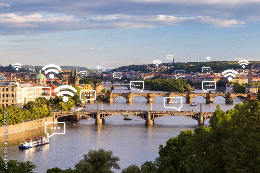 Scenic view of old buildings and bridges over Vltava River in Prague, Czech Republic at day. Wireless network connection, WiFi, smart city and online messaging concept.