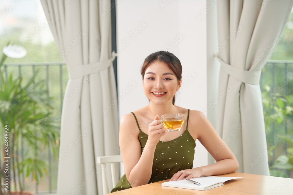 Pretty woman enjoying her morning tea on living room Pretty woman enjoying her morning tea on living room