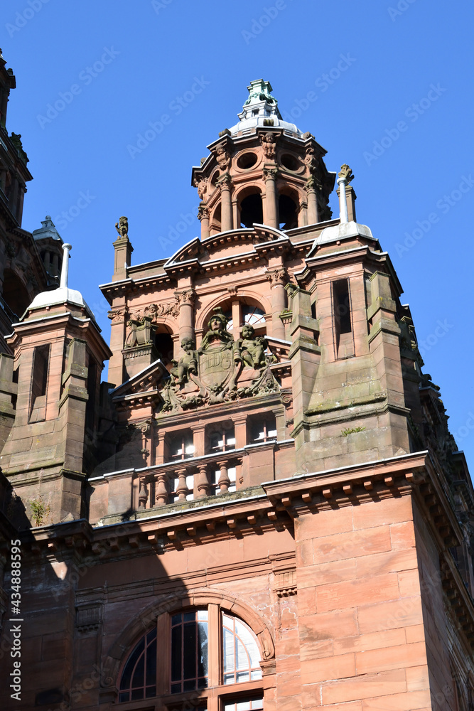 Fototapeta premium Ornate Carvings on Exterior of Public Museum Building against Blue Sky