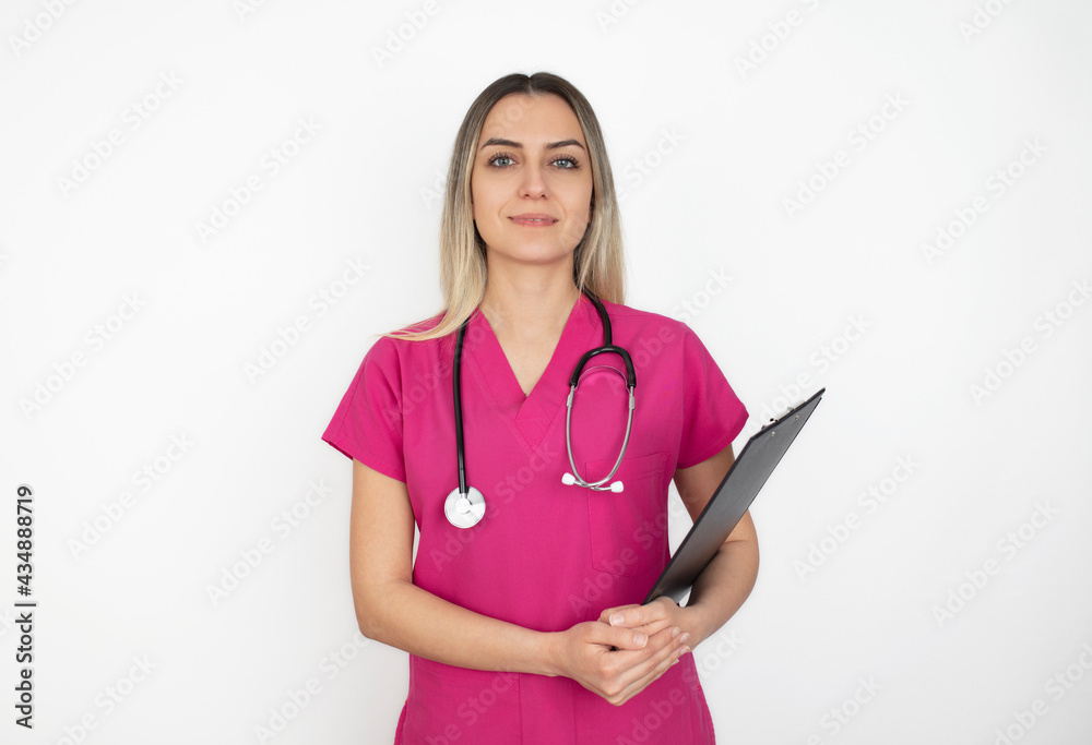 Nurse. Portrait on young woman nurse. medical student in her 20s wearing pink scrubs and stethoscope. Isolated on white background. Nurse. Portrait on young woman nurse. medical student in her 20s wearing pink scrubs and stethoscope. Isolated on white background.