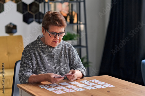 Принти на полотні Close up of female holding cards and playing solitaire