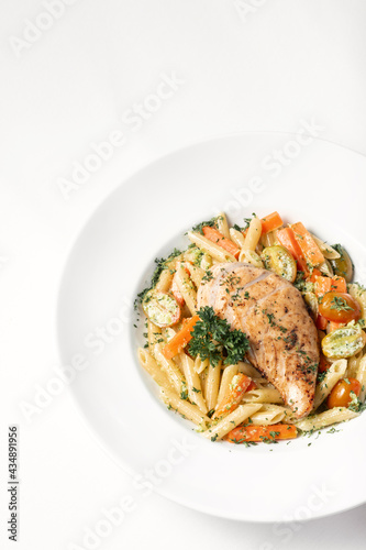 fried chicken breast with penne and saute vegetables pasta dish