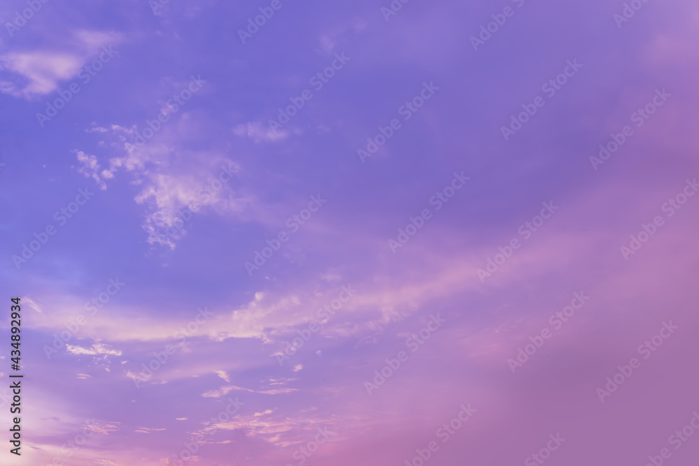Beautiful colored clear sky and small fluffy clouds in twilight time. Colorful background from outdoor natural sunset with copy space.