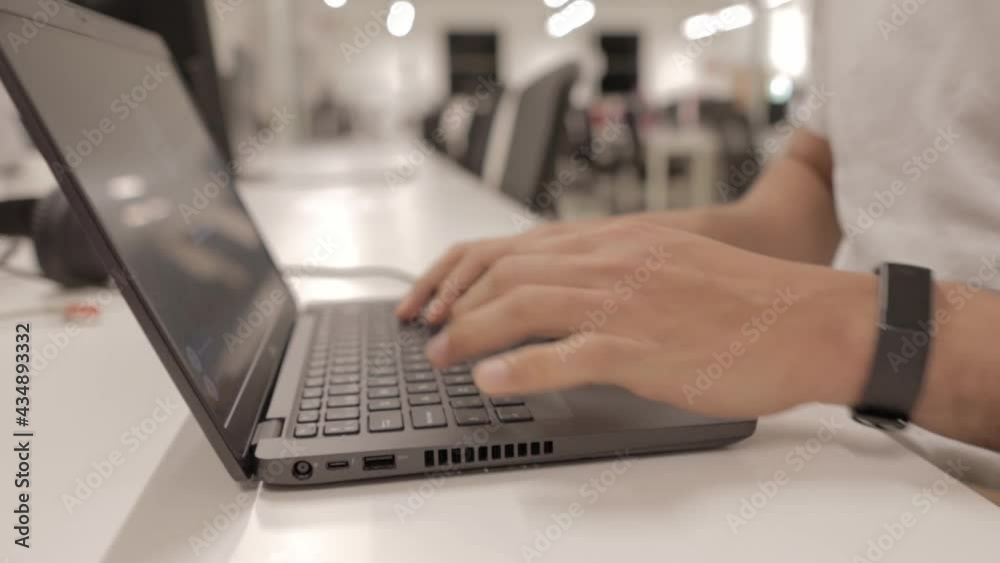 A close up of a man using a portable computer at office A close up of a man using a portable computer at office