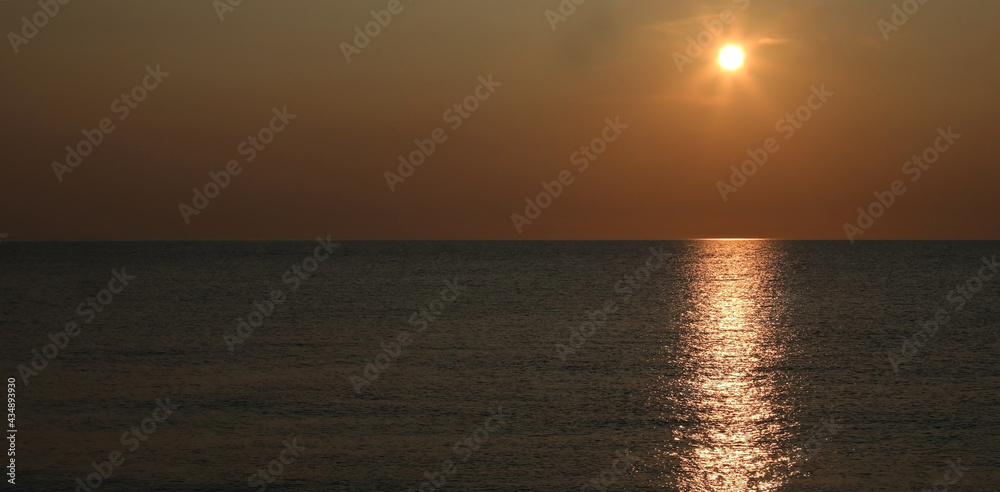 breathtaking sunset over the sea with warm orange red tones