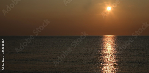breathtaking sunset over the sea with warm orange red tones © ChiccoDodiFC