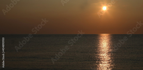 breathtaking sunset over the sea with warm orange red tones