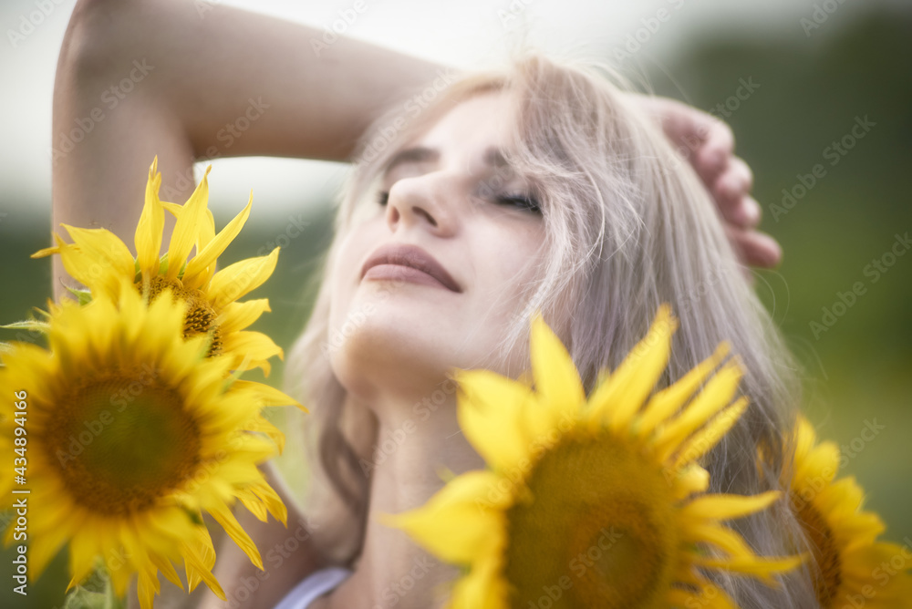 Young woman in sunflower field enjoying nature Young woman in sunflower field enjoying nature