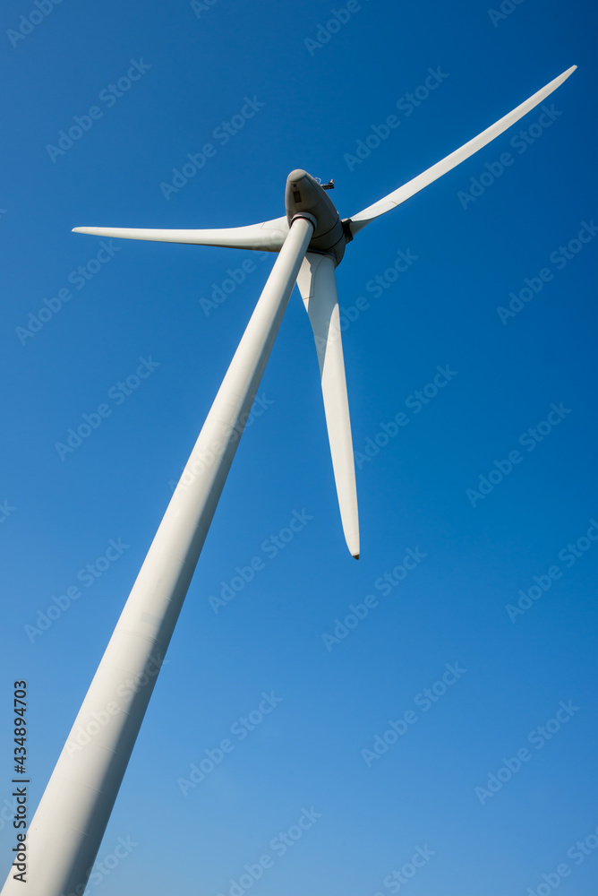 Close up of a wind turbine on blue sky background Close up of a wind turbine on blue sky background