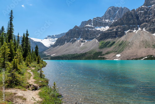 Beautiful turquoise waters of the Bow Lake with snow-covered peaks above it in Rocky Mountains  Banff National Park  Canada. 
