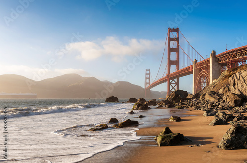Golden Gate Bridge view from California beach, ocean wave, sand and rocks in Marshall’s Beach, San Francisco, California