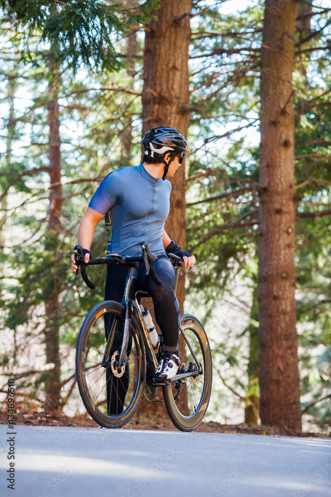 Fototapeta premium Portrait of a cyclist with his bike looking back