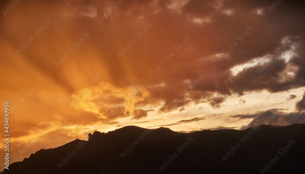 African sunset over Bale mountains covered in Harenna forest, east Africa. Dramatic view on illuminated clouds and rain over slopes of Bale mountains national park. African nature. Traveling Ethiopia