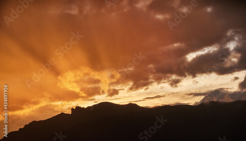 African sunset over Bale mountains covered in Harenna forest, east Africa. Dramatic view on illuminated clouds and rain over slopes of Bale mountains national park. African nature. Traveling Ethiopia