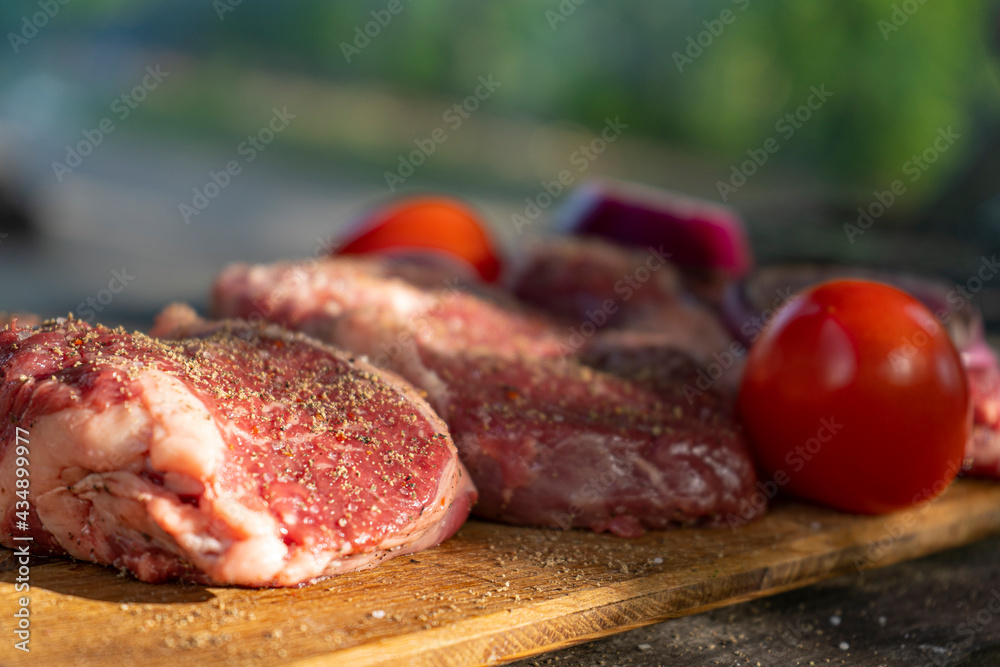 Cooking fresh marbled beef steak at a picnic. Outdoor cooking. Vacations