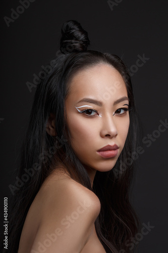 Beautiful Asian woman on a black background.