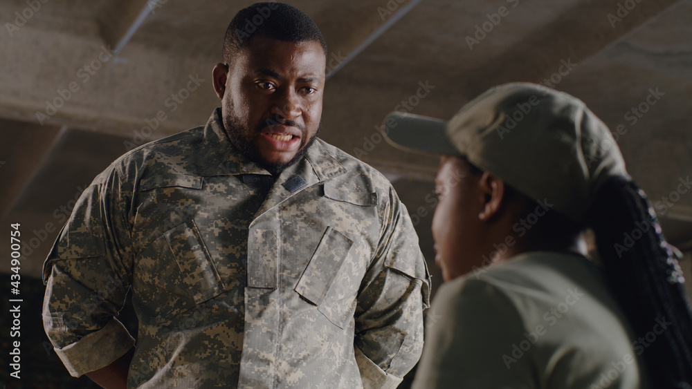 Black officer scolding female soldier Black officer scolding female soldier