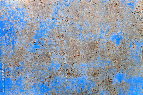 Fragment of an old peeling cracked rusty metal blue wall of an old barn © elenarostunova